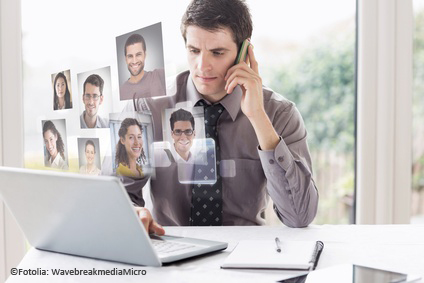 Composite image of business man on phone and laptop
