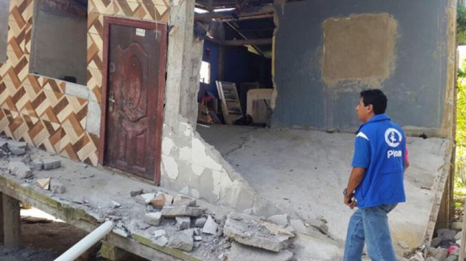 Plan International staff member assessing the earthquake damage in Manabi province.