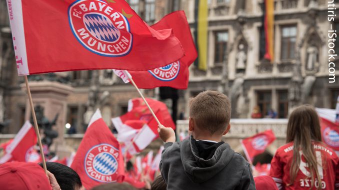 FC Bayern Munich fans in jerseys and with flags in front of Munich City Hall - an example of a strong sports brand