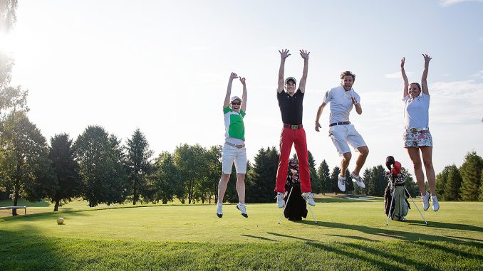 Young people playing golf at a golf club