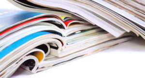 a stack of various journals and magazines