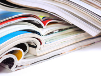 a stack of various journals and magazines