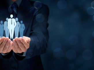 2 hands holding a group of stylized people as a symbol of human resources development