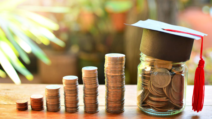 various piles of coins getting higher from left to right and a jar full of coins with a graduate hat on it