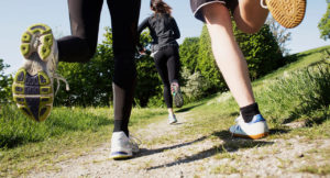 People from behind running with focus on shoes