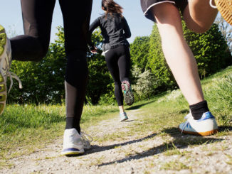 People from behind running with focus on shoes