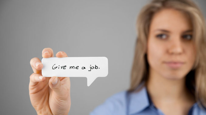 Young woman holding comics bubble with text "Give me a job"