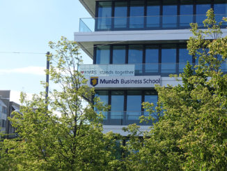 The building of Munich Business School with trees in the foreground