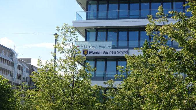 The building of Munich Business School with trees in the foreground