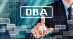 Business man touching a sign with DBA lettering
