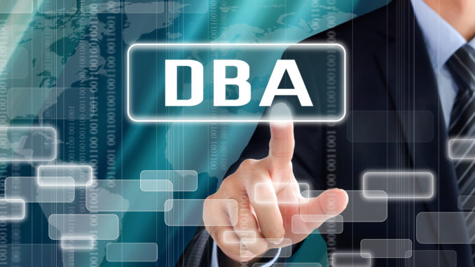 Business man touching a sign with DBA lettering