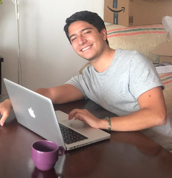 Sergio in front of his laptop while participating in online classes