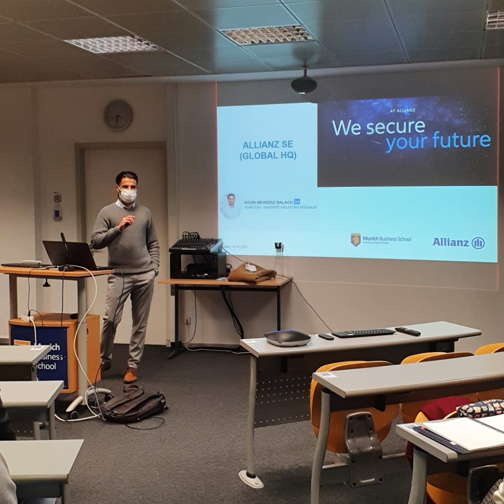 Nasir Balach (Allianz) presenting in the lecture hall during the career event at Munich Business School