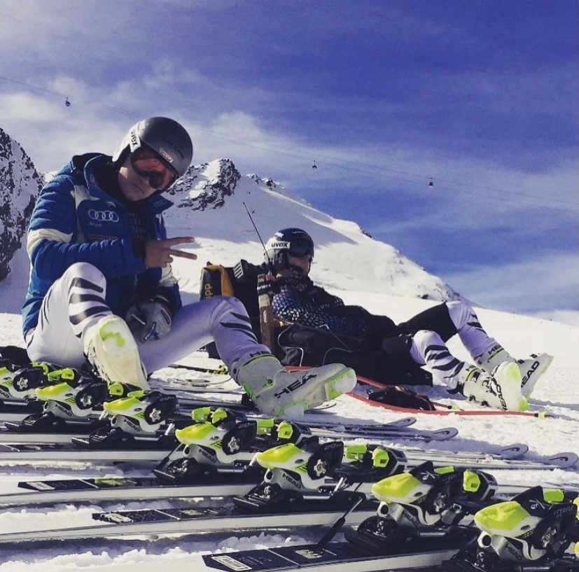 Max Maas sitting on a ski piste