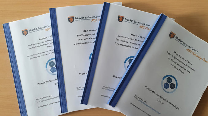 Munich Business School: MBS Outstanding Theses 2021 The MBS Outstanding Theses 2021 of Munich Business School lying side by side on a table