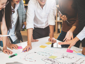 Group of people working on a project using mind mapping.