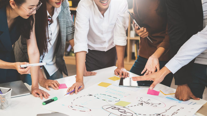 Group of people working on a project using mind mapping.