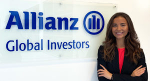 Julia Church, Bachelor's student at Munich Business School, standing next to the Allianz Global Investors logo during her internship.