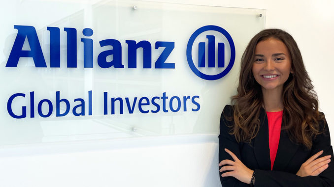 Bachelor's student Julia Church standing next to the Allianz Global Investors logo during her internship