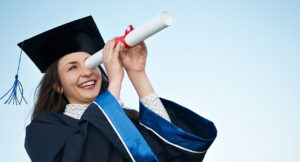 Graduate peers into the distance through the paper tube of her certificate, looking for exciting jobs after studying business