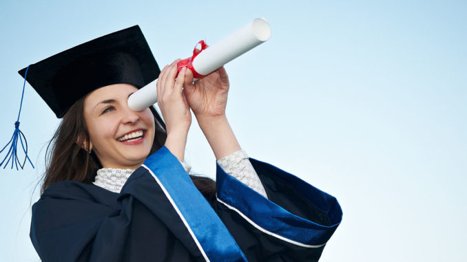 Graduate peers into the distance through the paper tube of her certificate, looking for exciting jobs after studying business