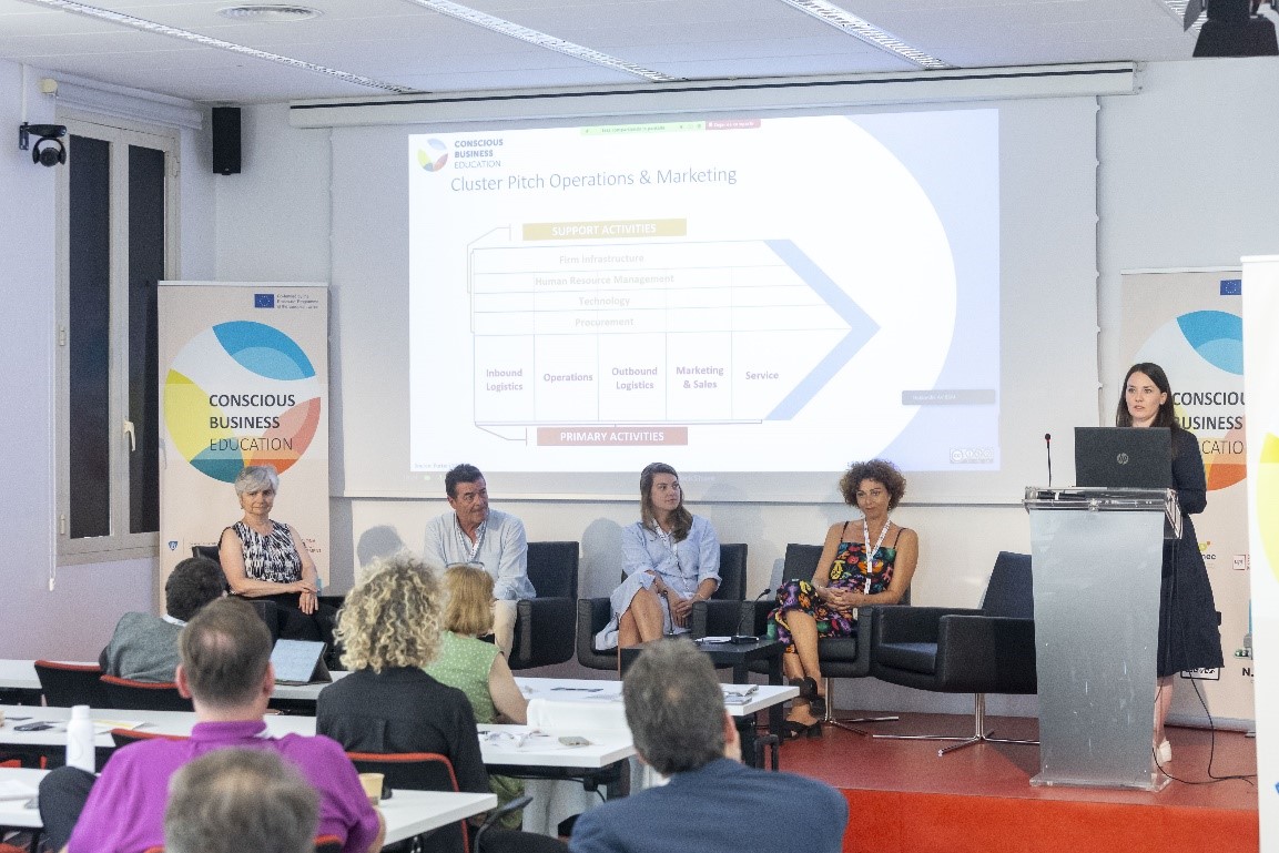 Multiplier Event of the "Conscious Business Education" Research Project in Barcelona; speakers on stage and participants from behind in the audience