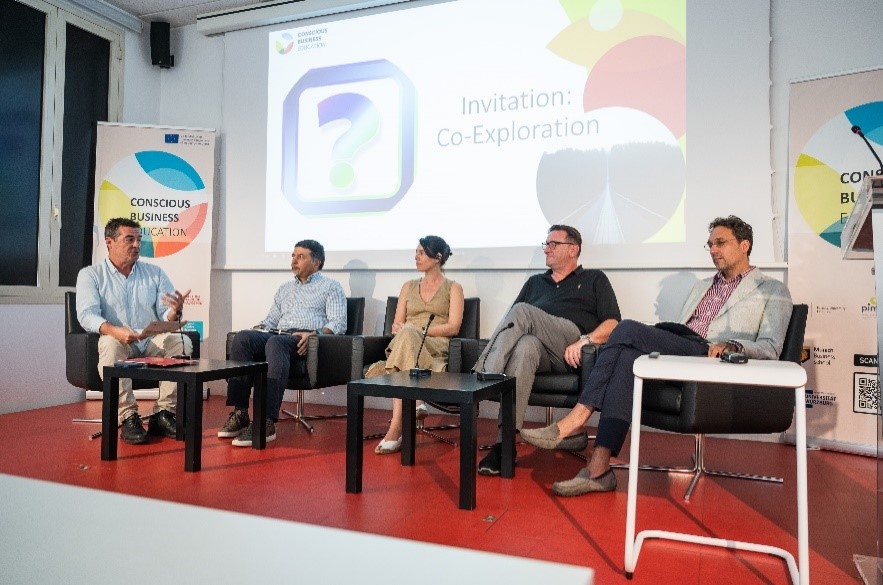 Multiplier Event of the "Conscious Business Education" Research Project in Barcelona; speakers on stage and participants from behind in the audience